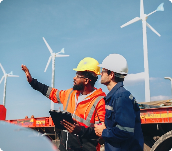 Two workers discussing wind turbines.