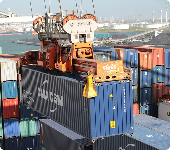 Crane lifting shipping container at port